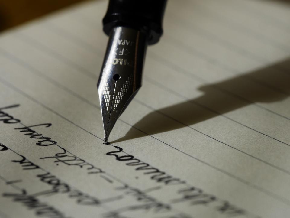 Fountain pen touching paper